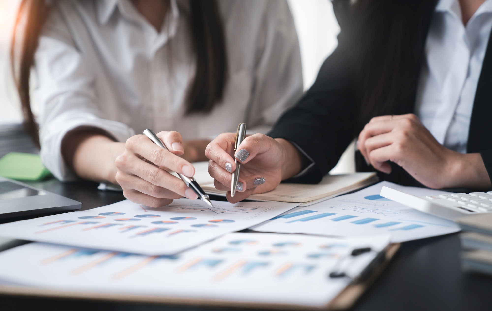 Financial analyst analysis business financial report on the document during a discussion at meeting